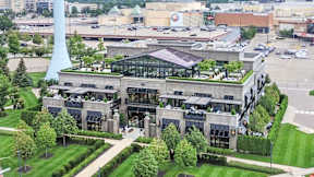 an aerial view of a building with a green roof and a parking lot