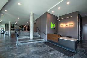 a lobby with a reception desk and a staircase