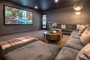 a living room with couches and a tv on the wall