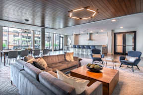 a living room with couches and chairs and a table
