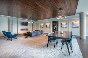 a conference room with a long wooden table and blue chairs