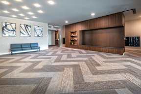 a lobby with a checkered floor and a large wooden wall and a television
