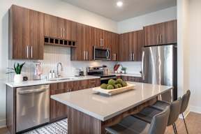 a kitchen with stainless steel appliances and a white counter top