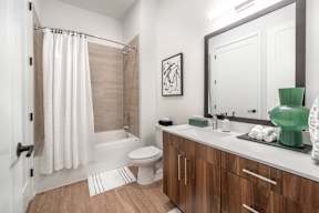 a bathroom with a large mirror and a toilet and a shower