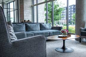 a living room with a couch and a table with flowers