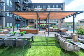 a patio with tables and chairs and a glass roof