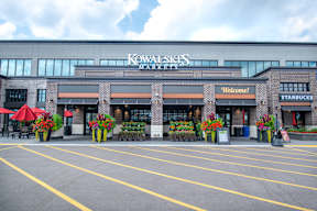 a building with a sign on it in front of a parking lot