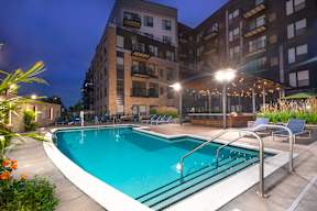 the swimming pool at night at the grove apartments