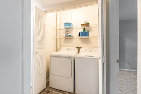 A white laundry room with a washer and dryer.
