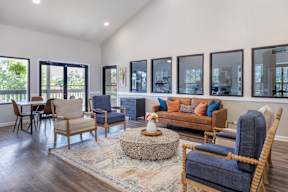A living room with a blue chair and a brown couch.