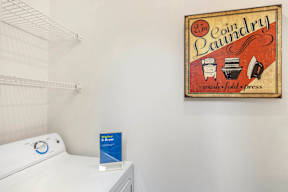 A white dryer is sitting next to a sign that says