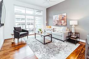 Living room with gray sofa and modern coffee table at Reserve on 3rd Apartments, Alabama, 35233