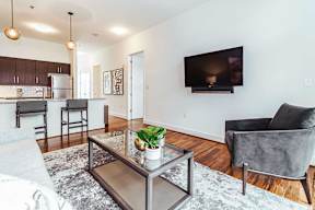 Open concept living area with kitchen breakfast bar at Reserve on 3rd Apartments, Birmingham, AL 35233