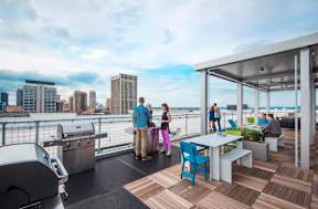 Rooftop terrace with outdoor grills and seating areas at Reserve on 3rd Apartments, Birmingham, 35233