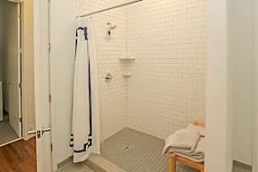 Subway tile shower with built in shelving at Reserve on 3rd Apartments, Birmingham, Alabama