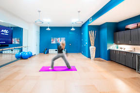 Fitness studio with yoga space and exercise equipment at Reserve on 3rd Apartments, Birmingham