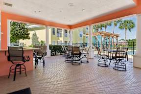 A patio with chairs and a table.