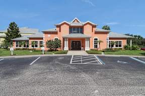 A building with a parking lot in front of it.