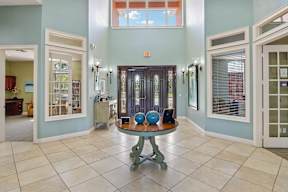 A room with a table and chairs in the middle of the room.