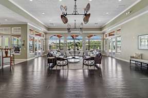 A large room with a table and chairs in the middle.