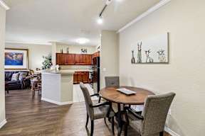 A dining room with a table and chairs.