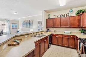 A kitchen with brown cabinets and a white countertop.