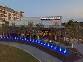 A modern building with Cantina Laredo Moder Mexican written on it.