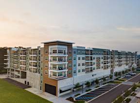 A large apartment complex with multiple buildings and parking lots.