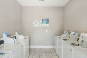a laundry room with washers and dryers