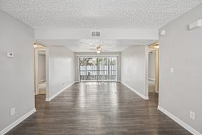 A long hallway with a door on the left and a door on the right.