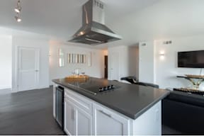 A modern kitchen with a large island and stainless steel appliances.