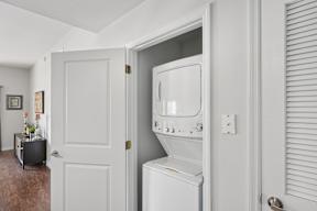 A white washing machine is in a doorway.