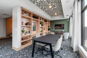 a conference room with a table and chairs and a large window