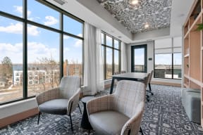 a conference room with chairs and a table and large windows