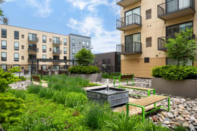 Vintage on Selby | St. Paul, MN |a courtyard with a fountain and benches in front of apartment buildings