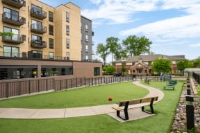 Vintage on Selby | St. Paul, MN |an apartment community with a park with benches and a ball on the grass