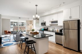Vintage on Selby | St. Paul, MN |a kitchen with stainless steel appliances and a island with three stools