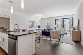 a living room with a kitchen and a dining table