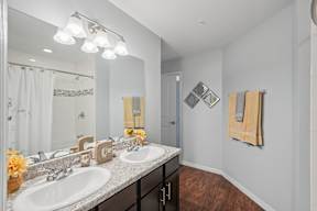 A bathroom with two sinks and a large mirror.