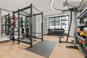 a home gym with weights and equipment and a window