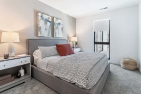 a bedroom with a large bed and a mirror