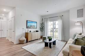 A living room with a black coffee table and a white couch.
