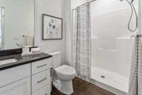 a bathroom with a toilet and a shower