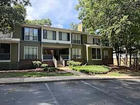 Apartment building with a green and beige exterior.