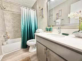 A bathroom with a white toilet, a white sink, and a white bathtub.