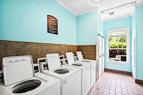 A row of washing machines in a laundromat.