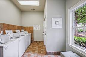 A laundry room with washers and dryers.