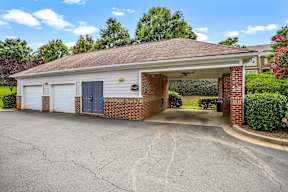 A two-car garage with a brick wall and a white door.