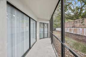 A long hallway with glass doors and windows.