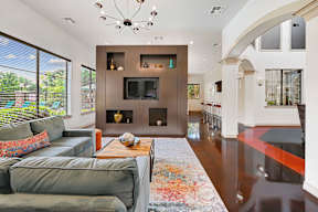a living room with couches and a coffee table and a fireplace